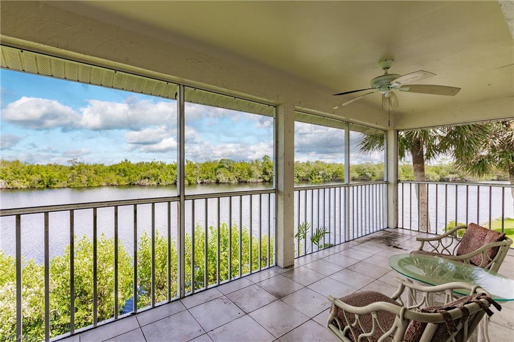 Unfurnished sunroom with a water view and ceiling fan