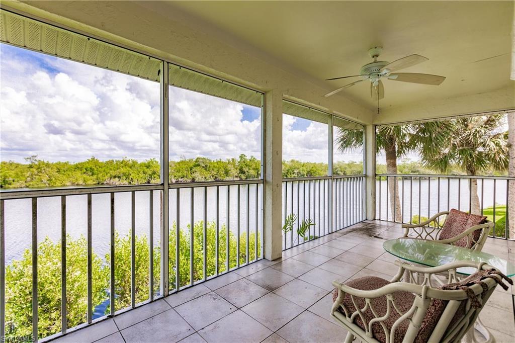 Sunroom / solarium with a water view and ceiling fan