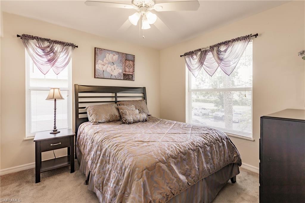 Bedroom featuring light colored carpet and ceiling fan