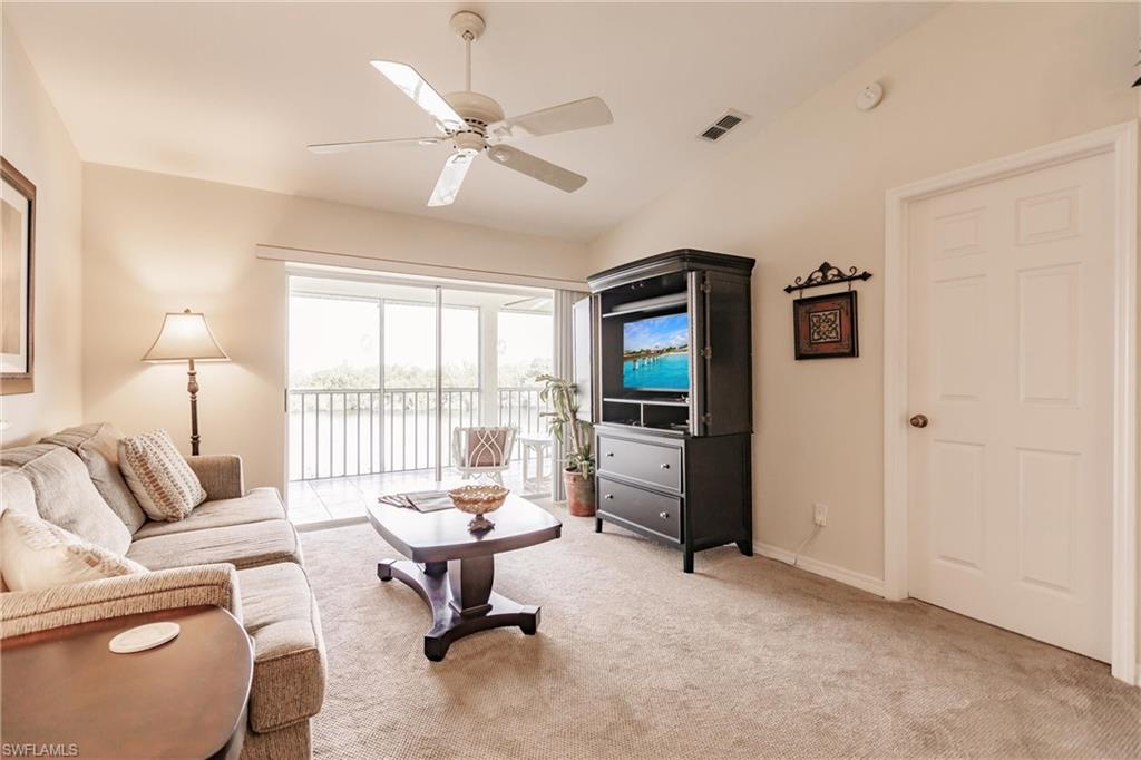 Carpeted living room with ceiling fan