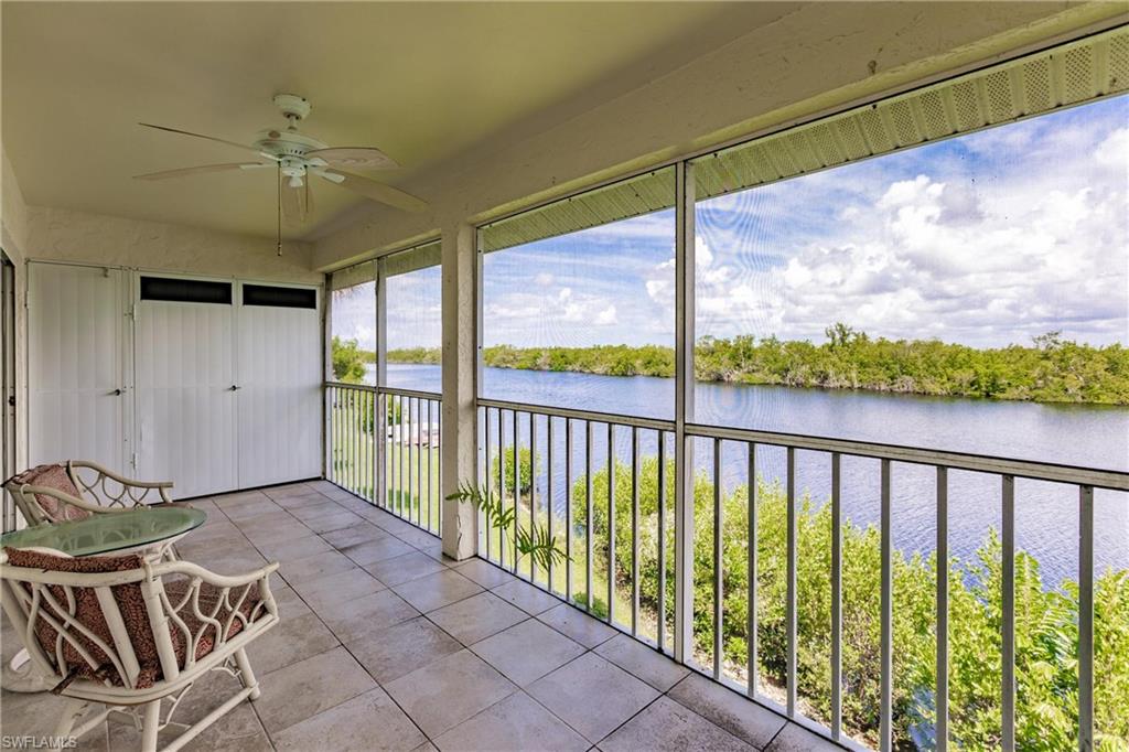 Unfurnished sunroom with a water view and ceiling fan