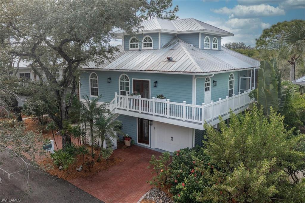 Key West Style Home featuring a metal roof