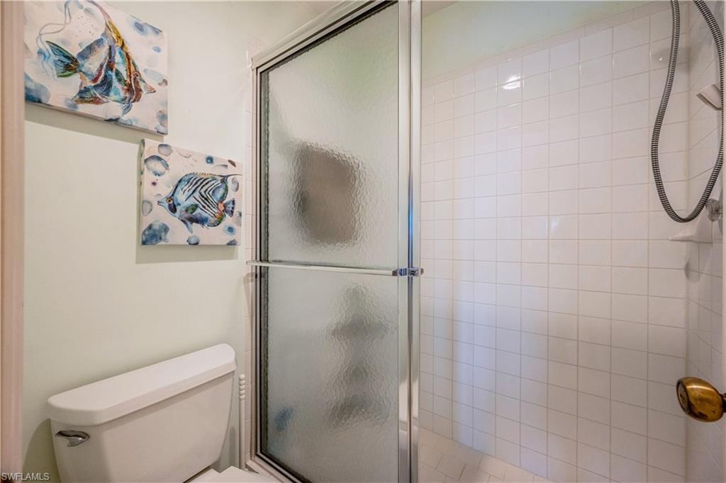 Full bathroom with a shower stall and toilet