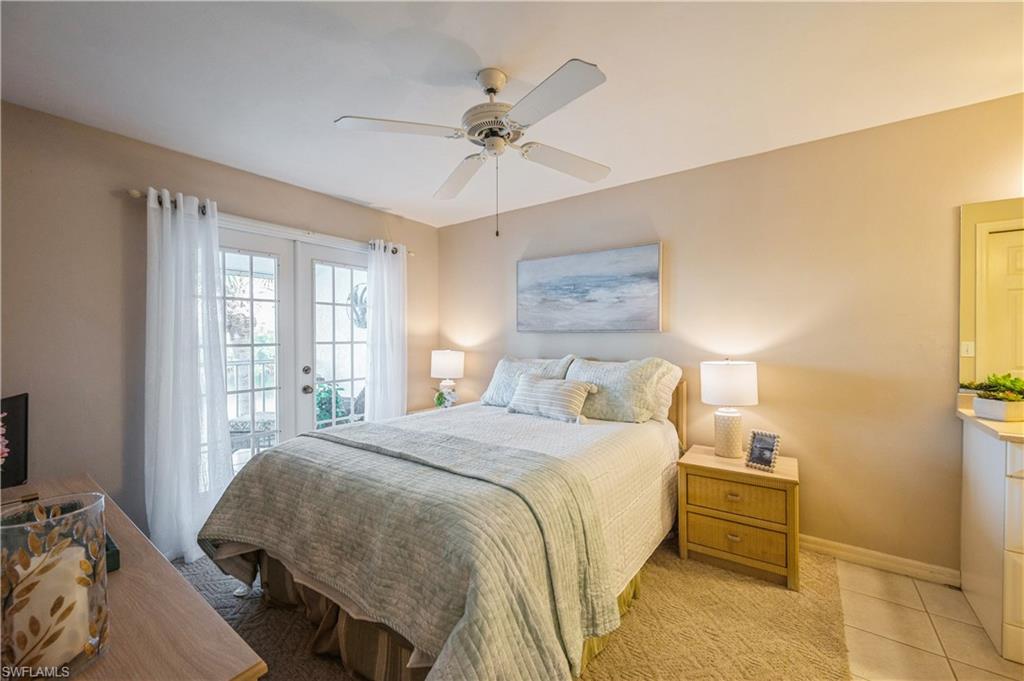 Bedroom featuring access to exterior, french doors, a ceiling fan, and light carpet