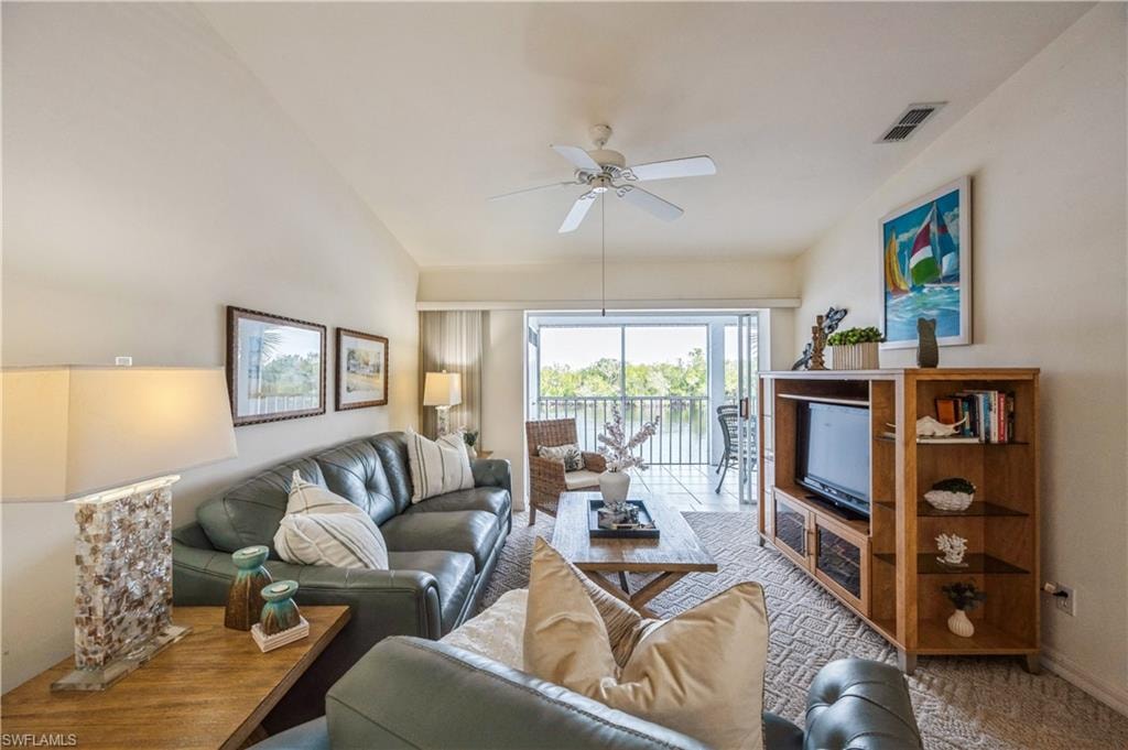 Living area with ceiling fan and vaulted ceiling