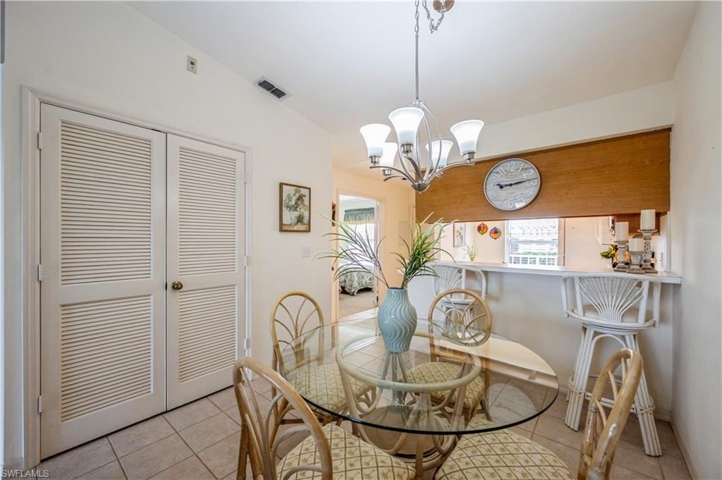Dining room featuring a chandelier and light tile patterned flooring