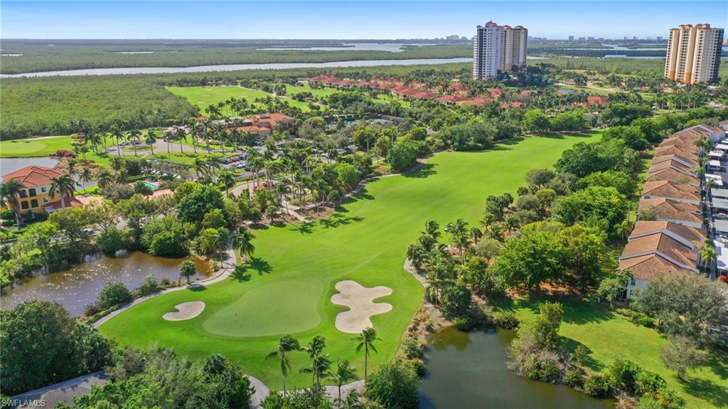 Aerial view of residential area featuring a large body of water and a golf club