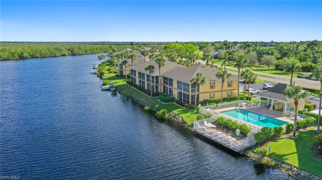 Bird's eye view of a nearby body of water and a pool area