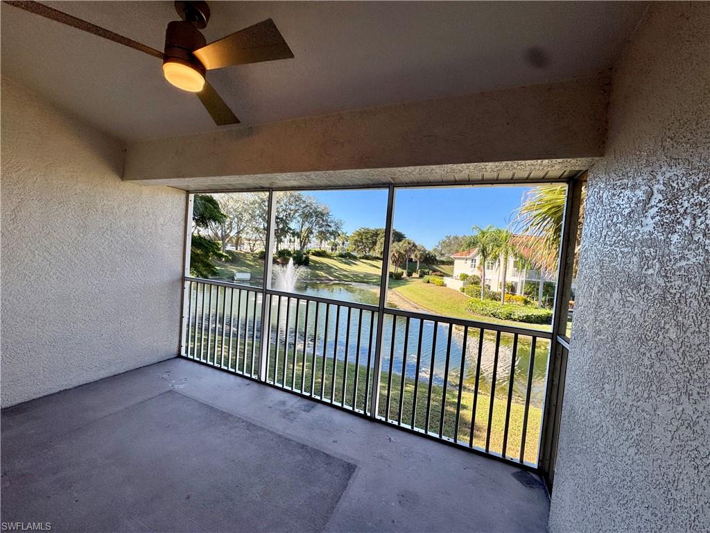 Balcony with a water view and ceiling fan