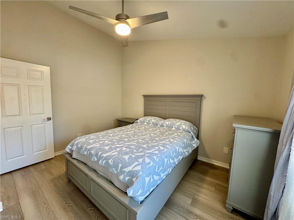 Bedroom with wood finished floors and a ceiling fan
