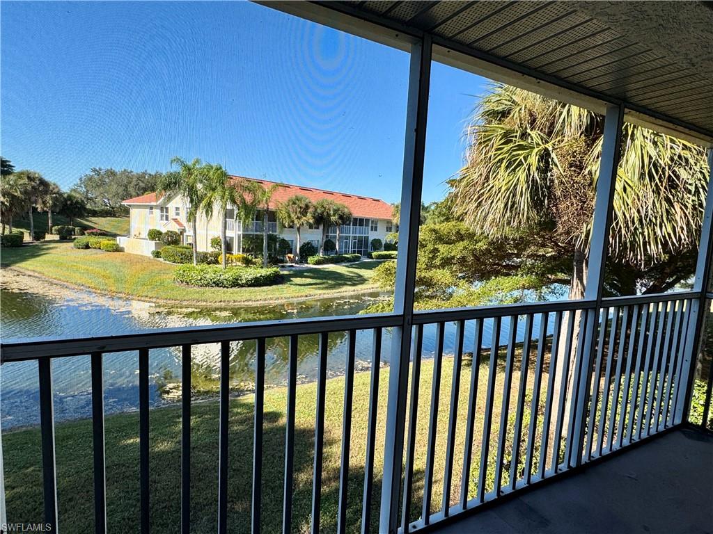 Balcony with a water view and a sunroom