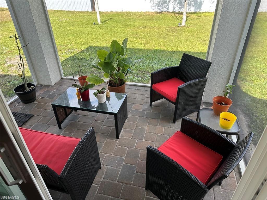 Sunroom / solarium featuring a patio area and plenty of natural light