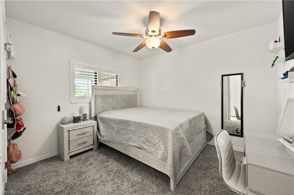 Bedroom with ceiling fan and carpet