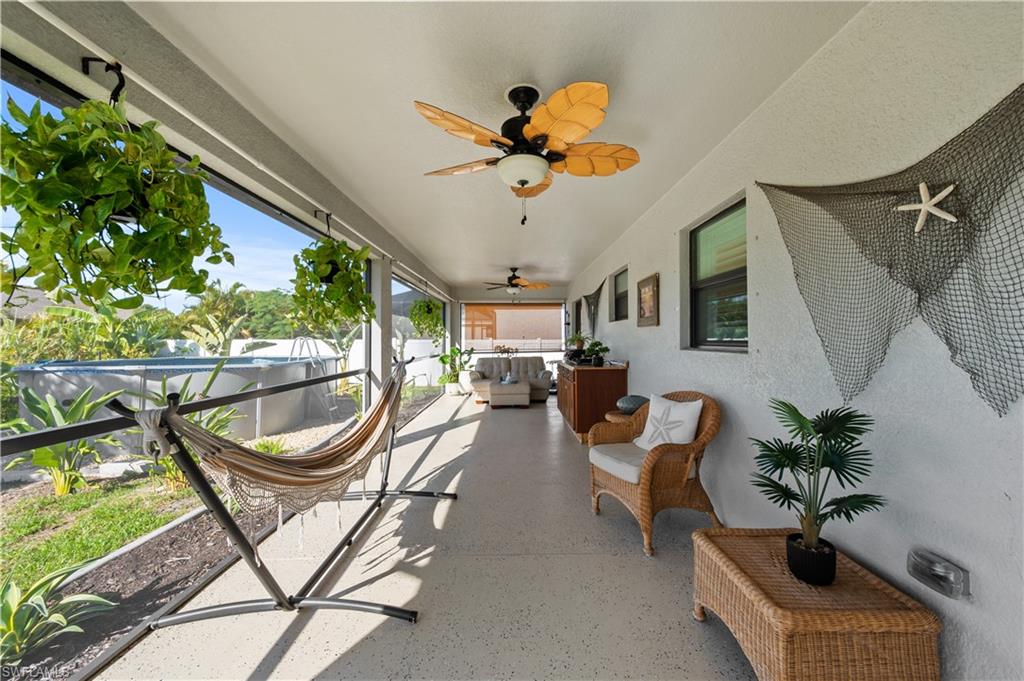 Sunroom featuring an outdoor living space and a ceiling fan