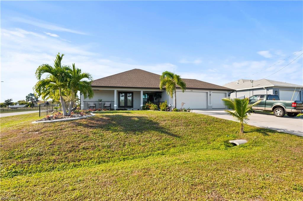 Ranch-style home with driveway, roof with shingles, a garage, a porch, and stucco siding