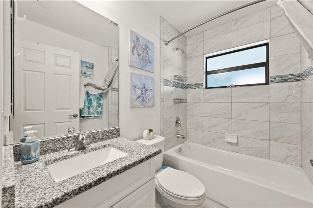 Full bath with shower / bathtub combination and vanity