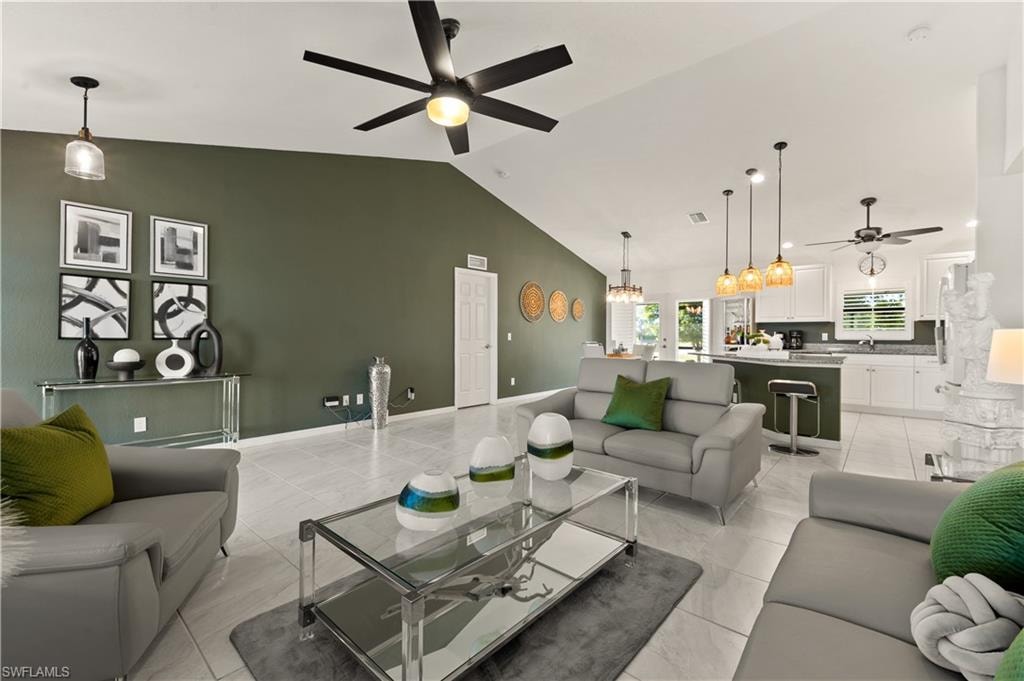 Living room with a ceiling fan and vaulted ceiling