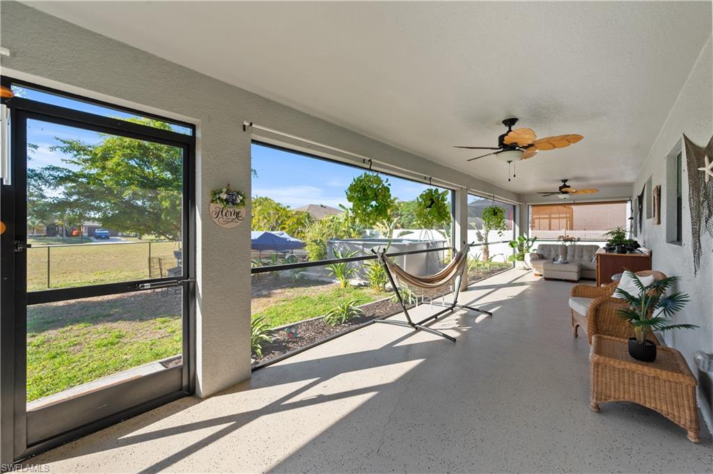 Sunroom / solarium with a ceiling fan and outdoor lounge area