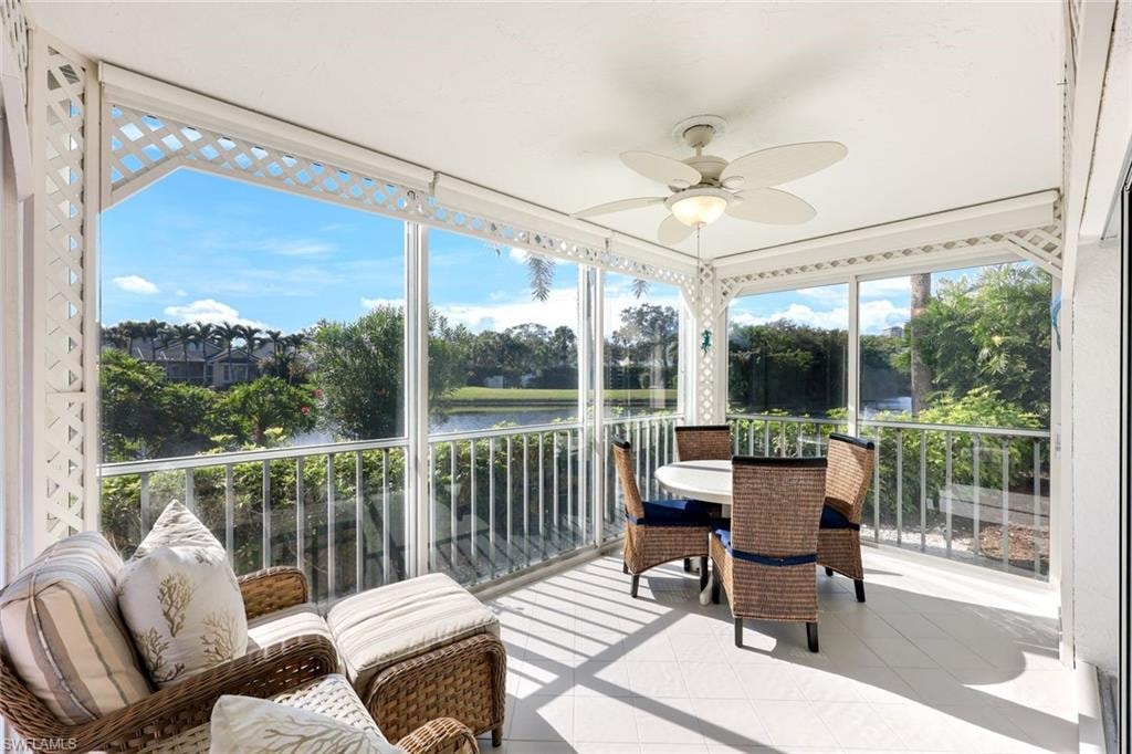 Sunroom featuring a water view, ceiling fan, and healthy amount of natural light