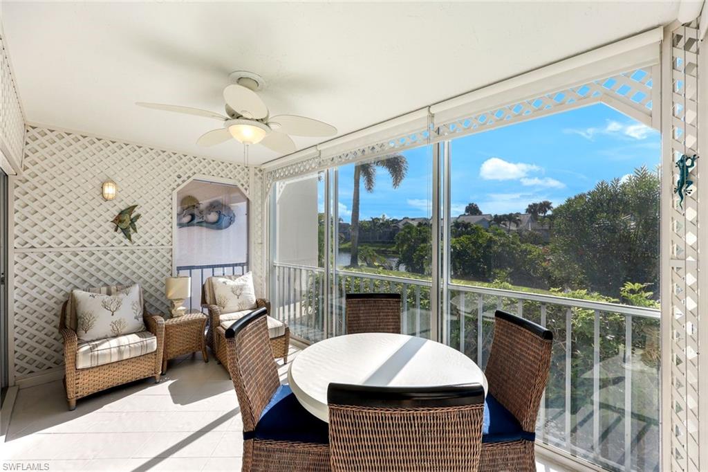 Sunroom / solarium with ceiling fan and a balcony