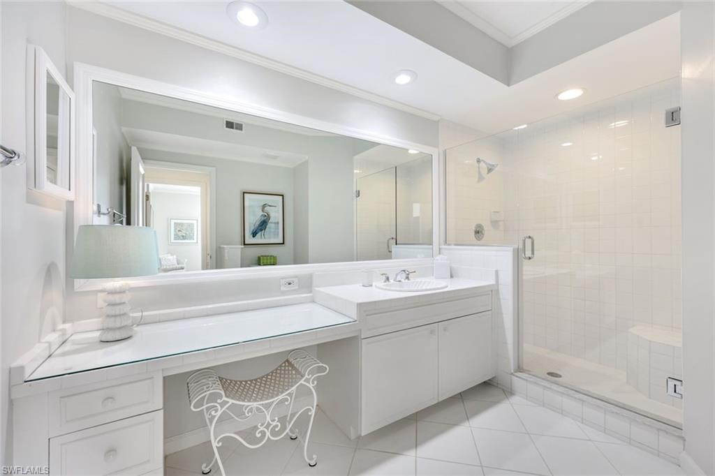 Full bathroom featuring crown molding, a stall shower, vanity, recessed lighting, and light tile patterned floors