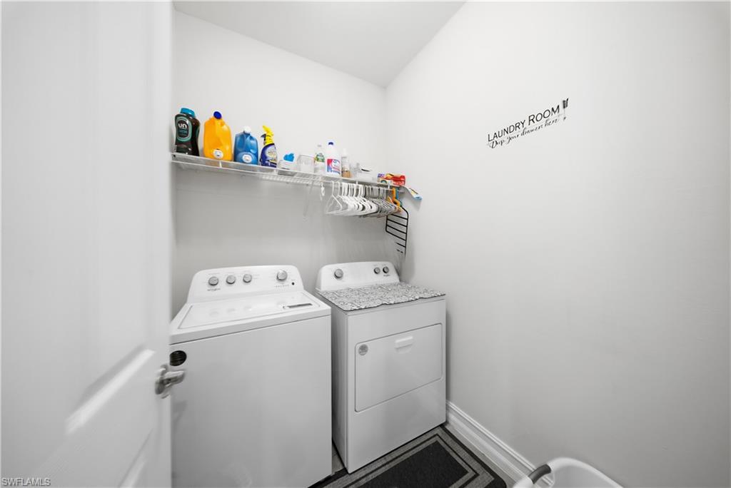 Laundry area featuring independent washer and dryer and baseboards