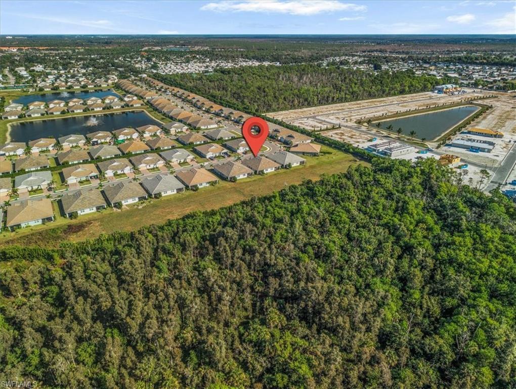 View of property location with nearby suburban area and a large body of water
