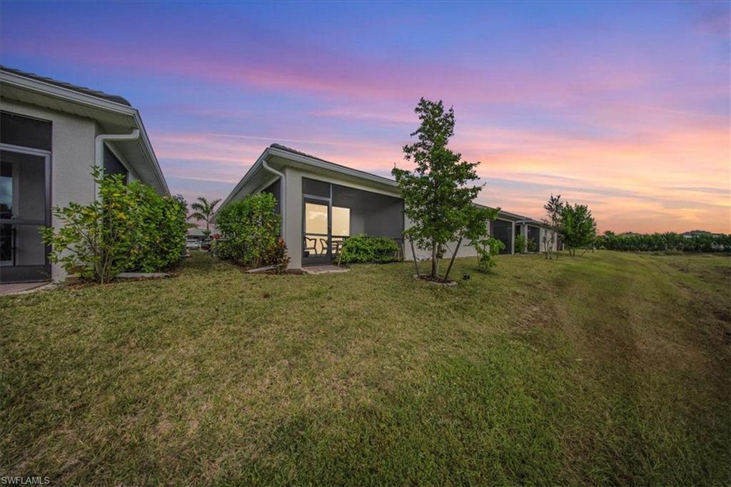 Yard at dusk featuring a yard