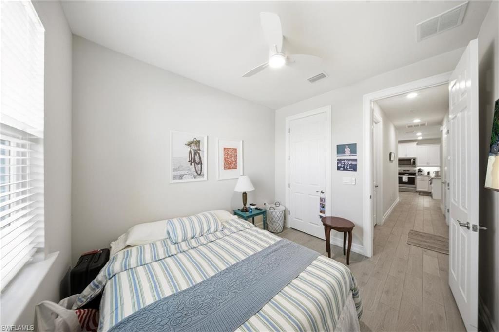 Bedroom with light wood finished floors and a ceiling fan