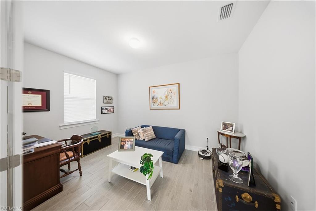 Living room with light wood-style floors and baseboards
