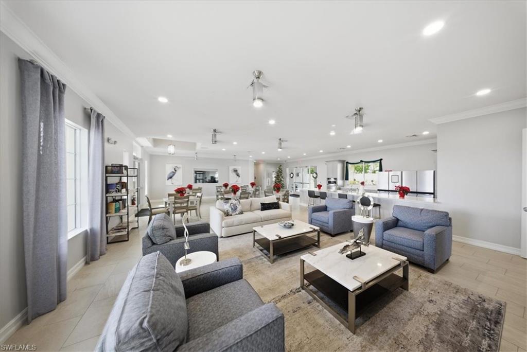 Living room featuring recessed lighting and crown molding