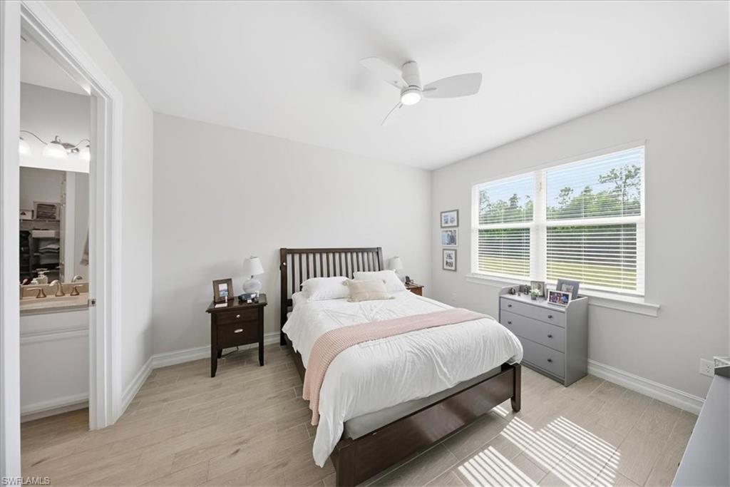 Bedroom with light wood-style floors and ceiling fan