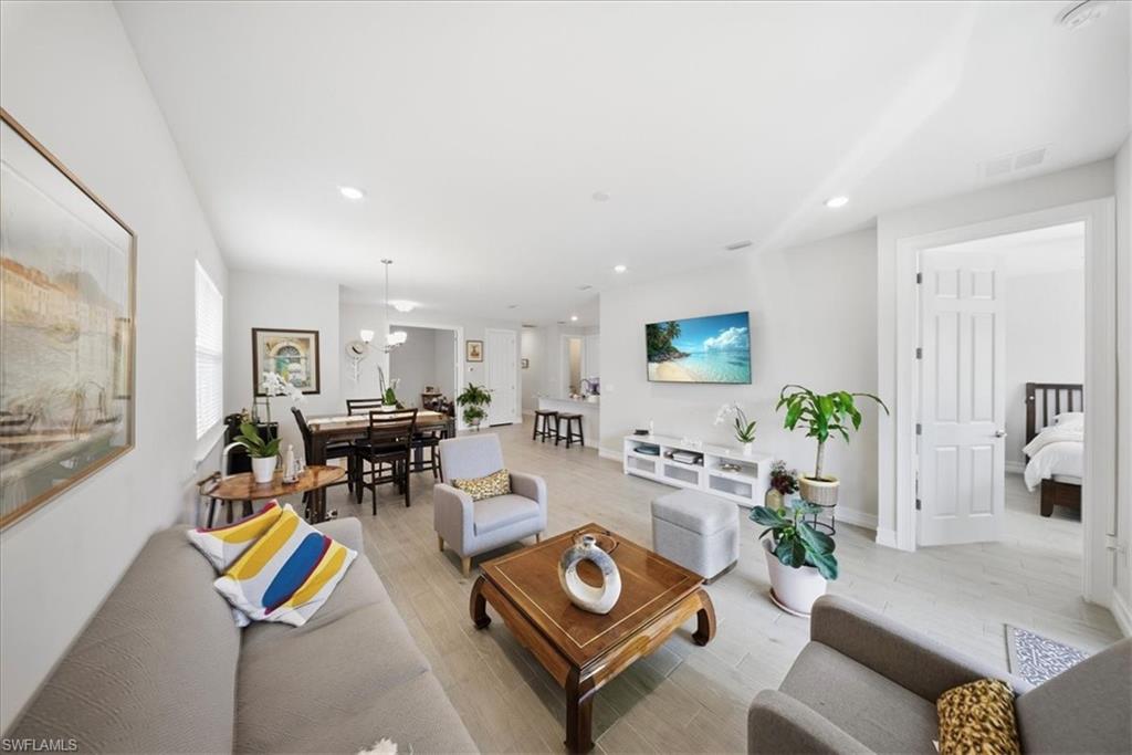 Living room with recessed lighting and light wood-style flooring