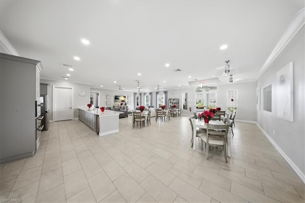 Dining area with crown molding, recessed lighting, and light tile patterned flooring