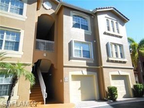 View of front of home featuring stucco siding and a garage