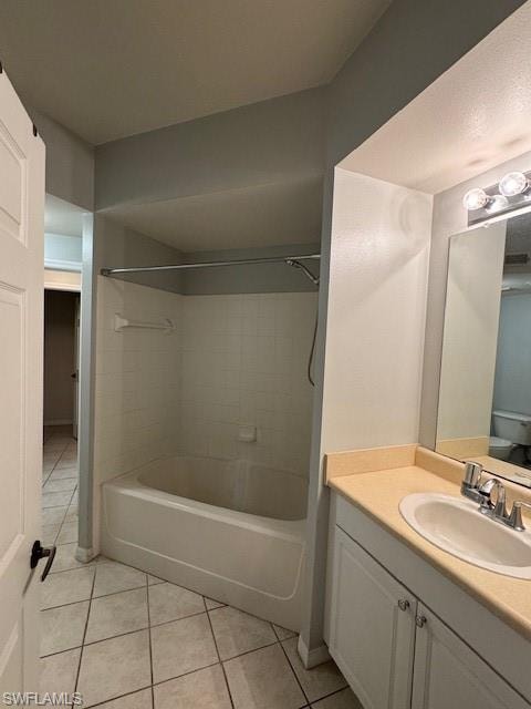 Bathroom featuring light tile patterned flooring, vanity, and bathtub / shower combination