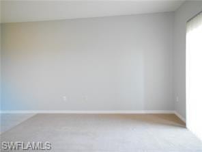 Empty room with baseboards and light carpet