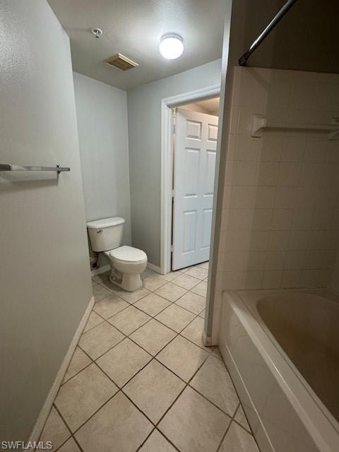 Bathroom featuring light tile patterned floors, a textured ceiling, and bathing tub / shower combination