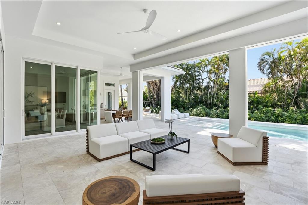 View of patio / terrace featuring ceiling fan, an outdoor living / dining area, and an outdoor pool