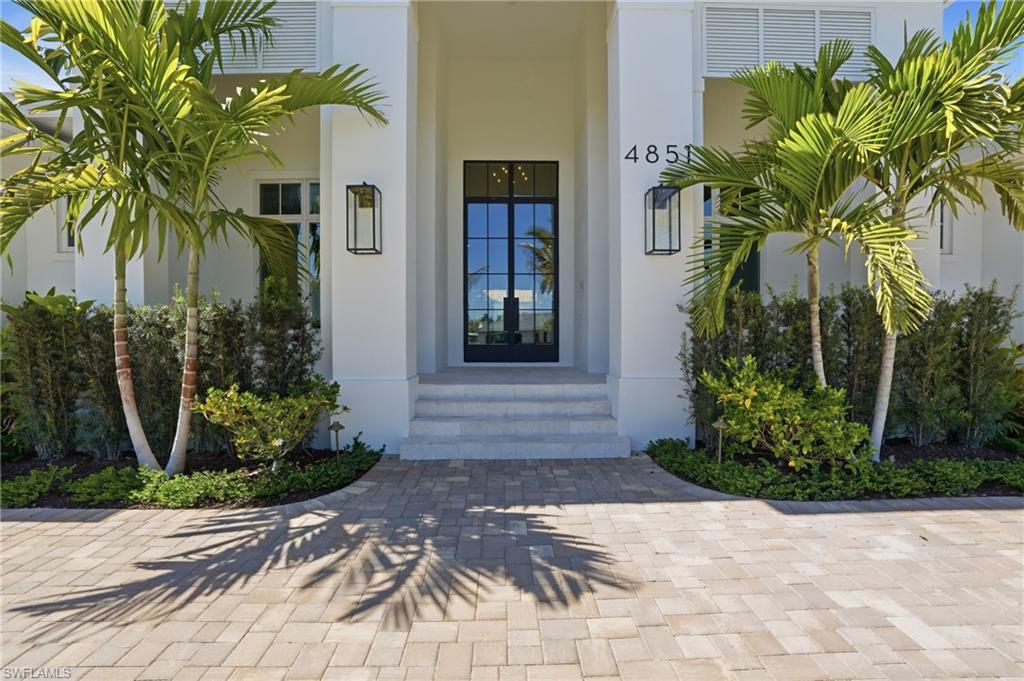 Doorway to property with stucco siding and french doors