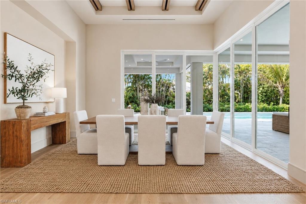 Dining area with wood-finish flooring and a textured area rug