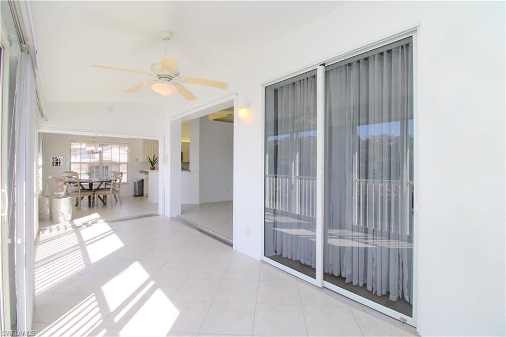 Unfurnished sunroom with ceiling fan
