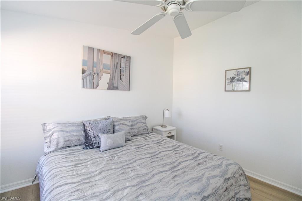 Bedroom with light hardwood / wood-style floors and ceiling fan