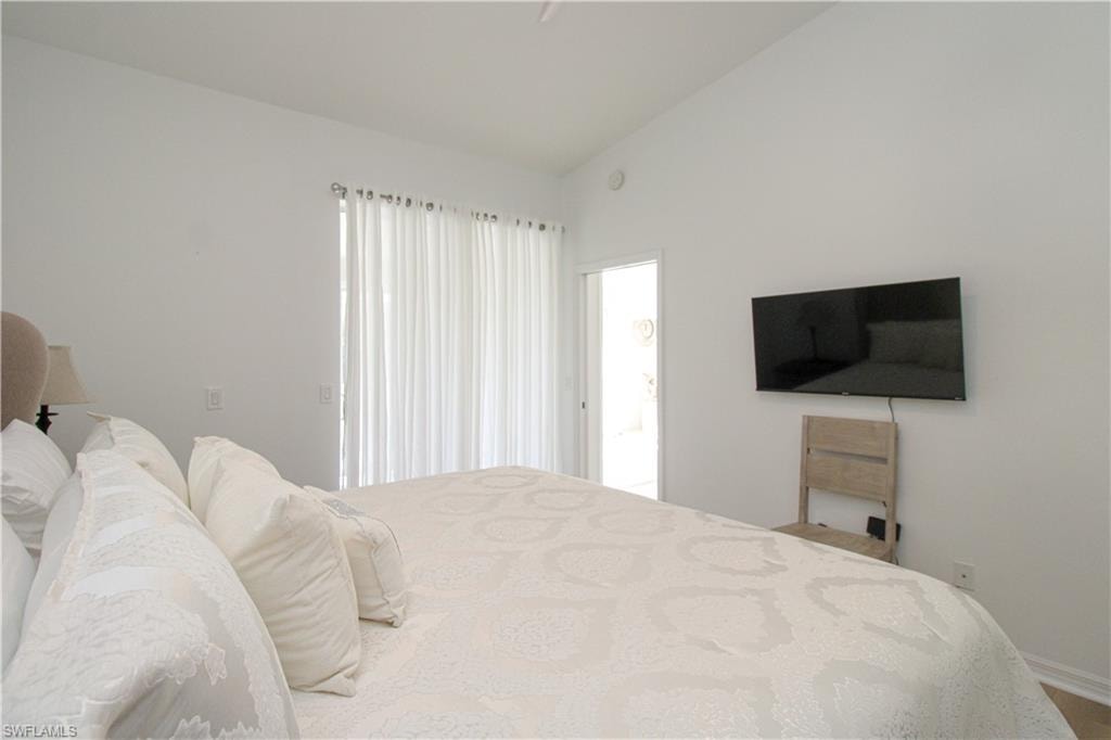 Bedroom featuring lofted ceiling