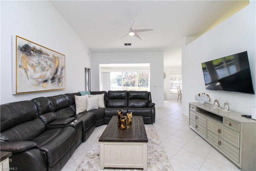 Living room featuring ceiling fan and light tile patterned floors
