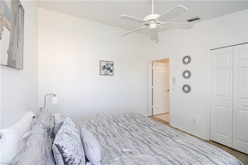 Bedroom featuring ceiling fan and a closet