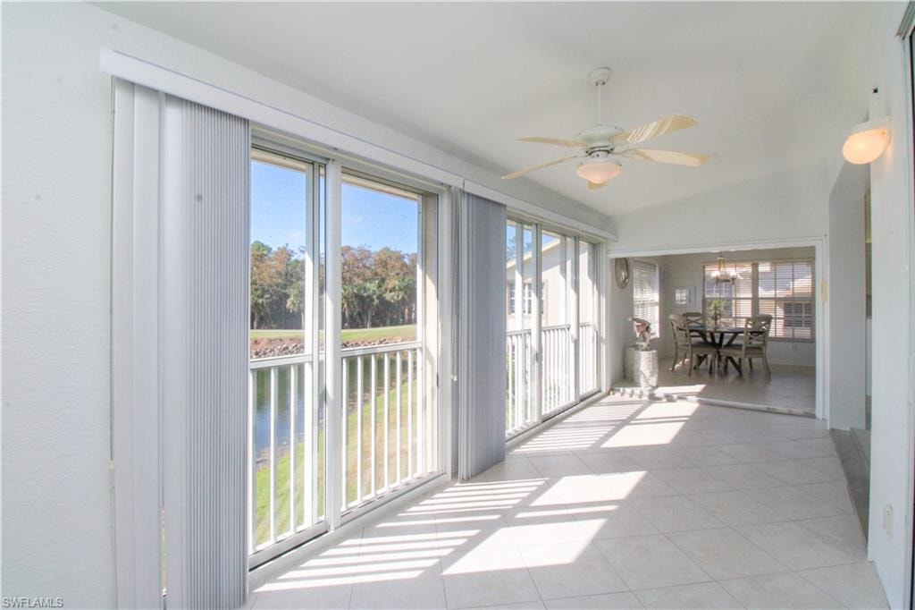 Unfurnished sunroom featuring vaulted ceiling and ceiling fan