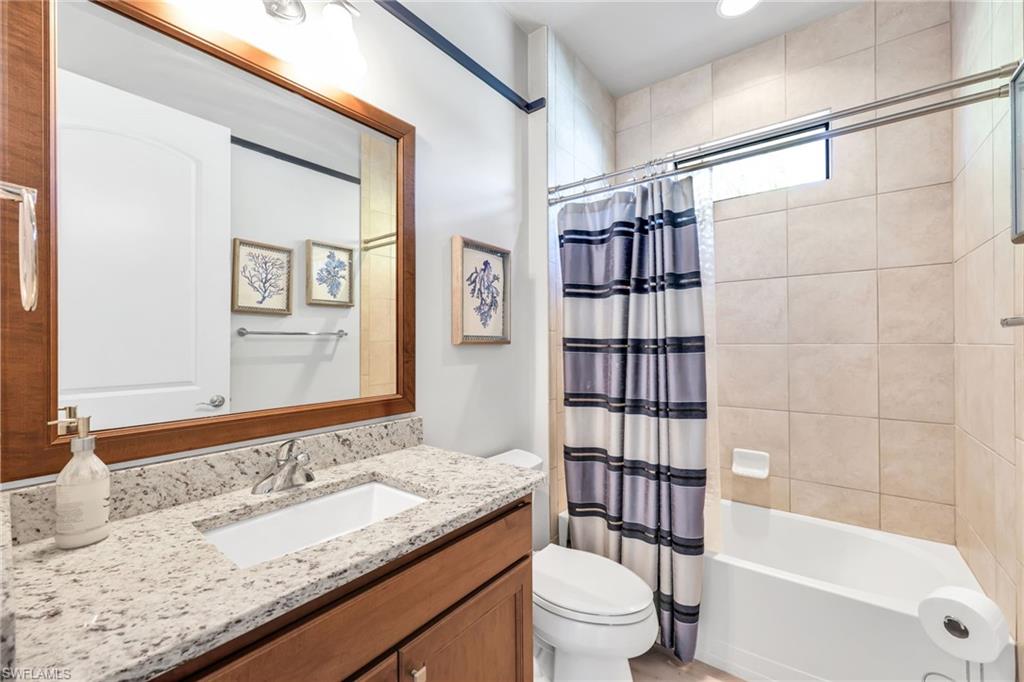 Bathroom with shower / bath combo and vanity