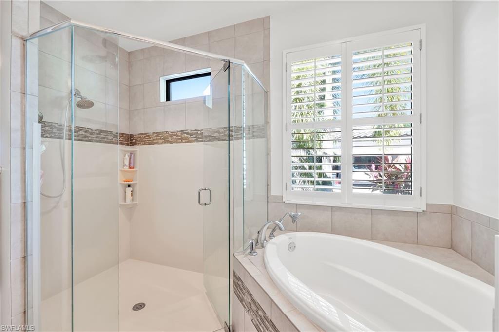 Full bath with a bath and a stall shower