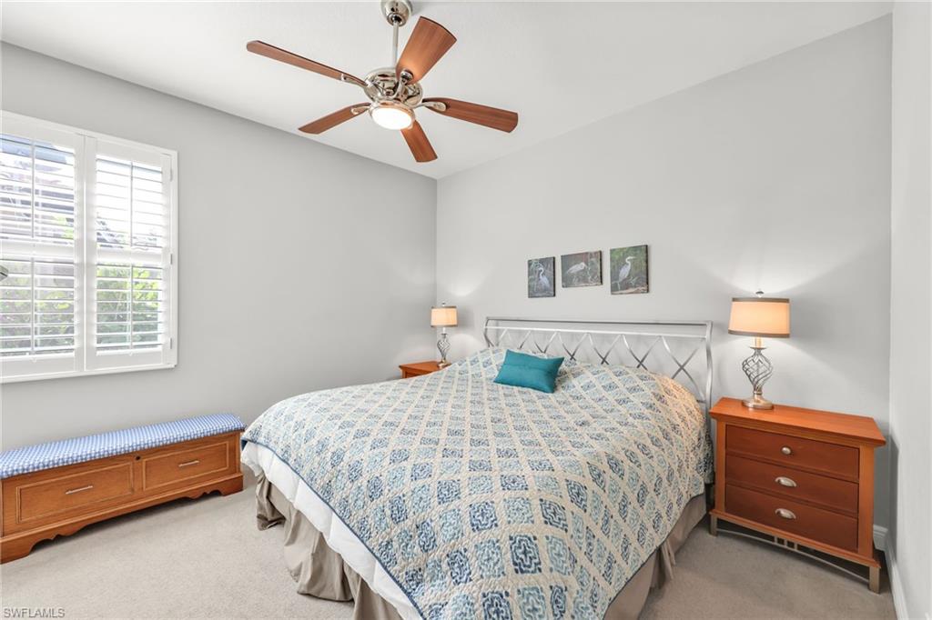Bedroom featuring a ceiling fan and light carpet